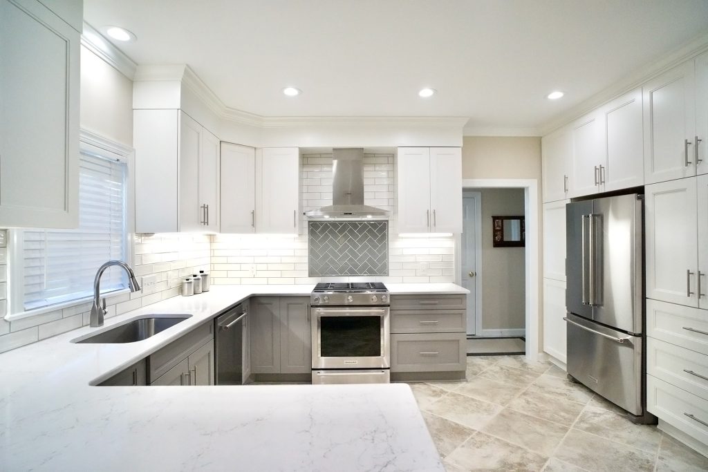 Bright new kitchen remodel with a wall of built in cabinet storage and refrigerator
